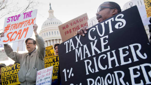 Demonstrators against the Republican tax reform bill hold a 'Peoples Filibuster to Stop Tax Cuts for Billionaires' protest rally outside the US Capitol on Capitol Hill in Washington, DC, November 30, 2017.
