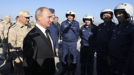 Russian President Vladimir Putin (C, front) meets with servicemen as he visits the Hmeymim air base in Latakia Province, Syria December 11, 2017.