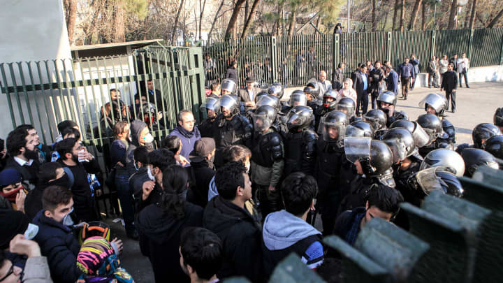 Iranian students scuffle with police at the University of Tehran during a demonstration driven by anger over economic problems, in the capital Tehran on December 30, 2017.