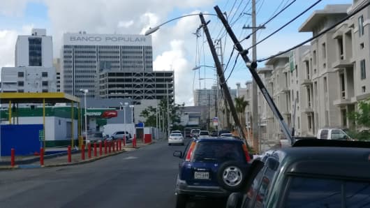 Damaged power lines hang over a street in San Juan, Puerto Rico.