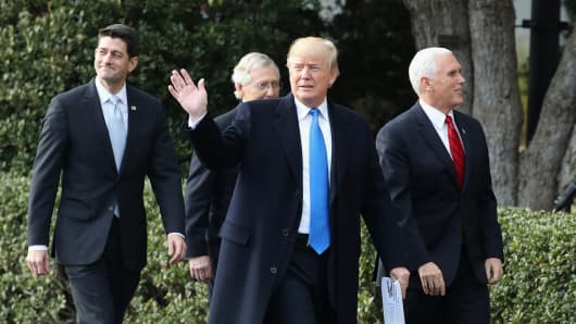 President Donald Trump (C), House Speaker Paul Ryan (R-WI) (L), Senate Majority Leader Mitch McConnell (R-KY) (2nd L) and Vice President Mike Pence make their way to a news conference announcing Congress passing the Tax Cuts and Jobs Act on the South Lawn of the White House on December 20, 2017 in Washington, DC.