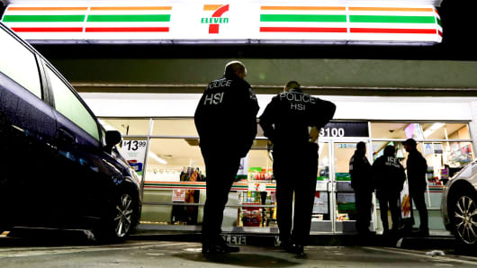U.S. Immigration and Customs Enforcement agents serve an employment audit notice at a 7-Eleven convenience store Wednesday, Jan. 10, 2018, in Los Angeles. Agents said they targeted about 100 7-Eleven stores nationwide Wednesday to open employment audits and interview workers.