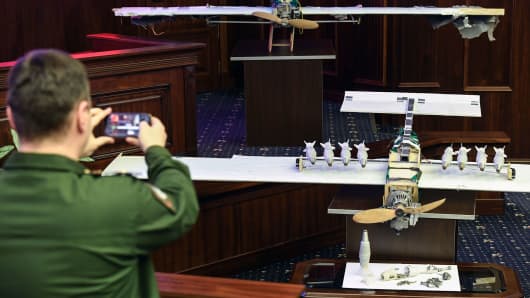 An officer takes pictures of drones allegedly used during recent attacks on Russia's bases in Syria, at a briefing in the Russian Defence Ministry headquarters in Moscow on January 11, 2018.