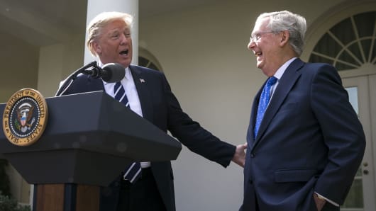 President Donald Trump, left, speaks as Senate Majority Leader Mitch McConnell, a Republican from Kentucky, laughs during a news conference in the Rose Garden of the White House in Washington, D.C.
