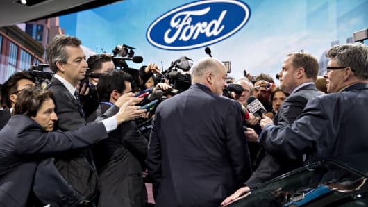 Jim Hackett, president and chief executive officer of Ford Motor Co., center, speaks to members of the media at an event during the 2018 North American International Auto Show (NAIAS) in Detroit, Jan. 14, 2018.