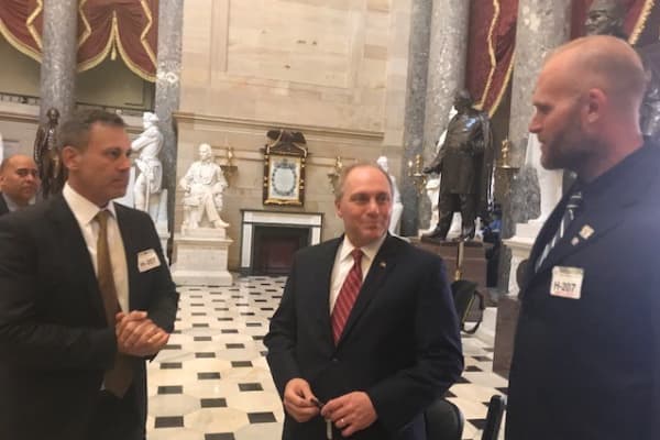 Nick Etten (L) and retired NFL offensive lineman Kyle Turley (R) discuss medical cannabis with Rep. Steve Scalise (C) in the Capitol.