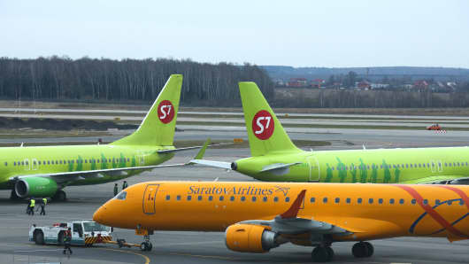 Passenger aircraft operated by S7 Airlines and Saratov Airlines stand before flight at Domodedovo Airport ZAO in Domodedovo, Russia, on Friday, April 21, 2017. Domodedovo, also known as Moscow Airport, is owned by Russian billionaire Dmitry Kamenshchik. Photographer: Andrey Rudakov/Bloomberg