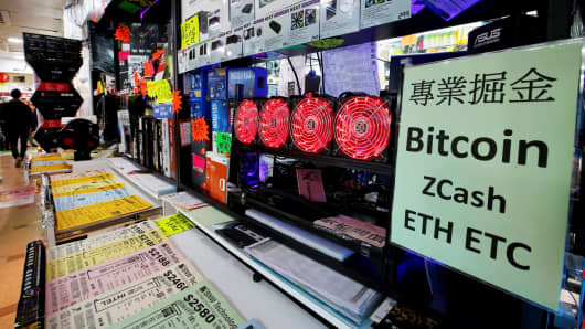 A cryptocurrency mining computer equipped with four cooling fans is seen on display at a computer mall in Hong Kong, January 29, 2018.