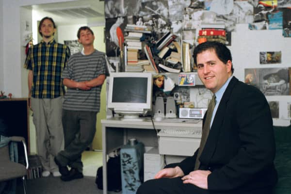 In this Friday, Feb. 26, 1999, file photo, Michael Dell, foreground, sits in the dorm room at the University of Texas in Austin, Texas, where he launched his enterprise as a college freshman.