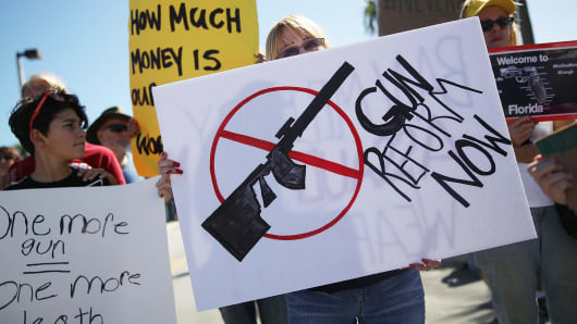 Activists protest in front of Kalashnikov USA, a gun manufacturer that makes an AK-47 rifle, on February 25, 2018 in Pompano Beach, Florida.