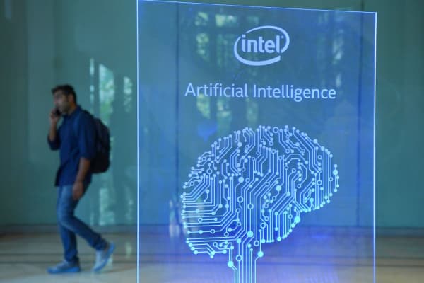 A visitor at Intel's Artificial Intelligence (AI) Day walks past a signboard during the event in Bangalore, India