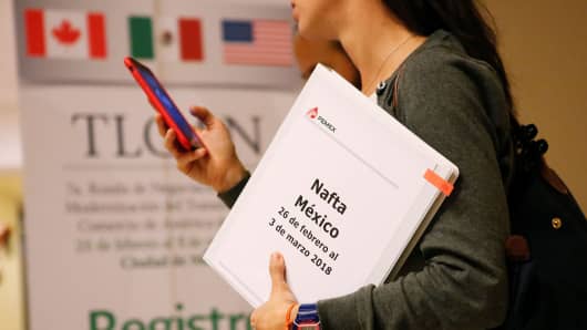 A member of the Mexican negotiation team checks her phone during a lunch break at the hotel where the seventh round of NAFTA talks involving the United States, Mexico and Canada takes place, in Mexico City, Mexico February 28, 2018.