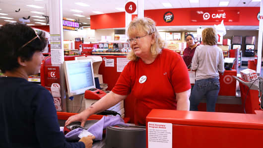 A Target worker helps a customer at a Target store in San Rafael, California.