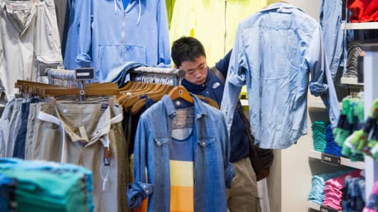 A customer shops for shirts at an American Eagle Outfitters store in San Francisco.