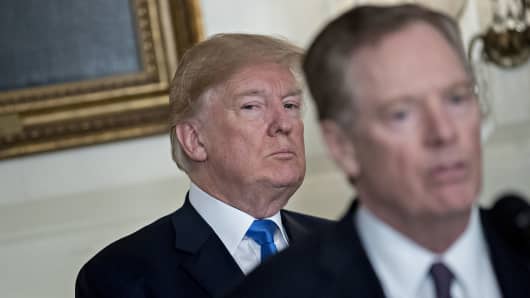 President Donald Trump listens as Robert Lighthizer, U.S. trade representative speaks before Trump signs a presidential memorandum targeting China's economic aggression in the White House.