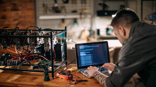 With venture funding aplenty, numerous blockchain applications have been developed and many more are in the works. Here, a computer programmer sets up a mining rig to mine for bitcoin.