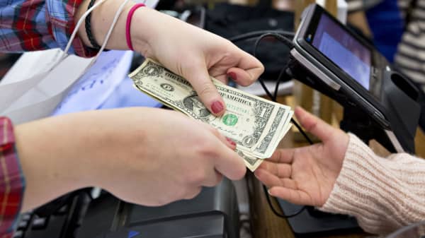 A cashier, left, returns cash to a customer at a Vineyard Vines store in Illinois.