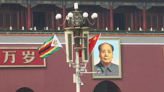 Chinese and Zimbabwean national flags in front of the Tian'anmen Rostrum on April 3, 2018, in Beijing, China.