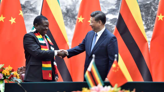 Zimbabwe's President Emmerson Mnangagwa (L) shakes hands with Chinese President Xi Jinping at the Great Hall of the People in Beijing, China, on April 3, 2018.