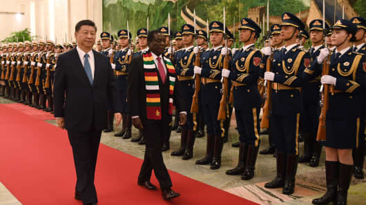Zimbabwe's President Emmerson Mnangagwa (C) with Chinese President Xi Jinping (L) during a welcome ceremony at the Great Hall of the People in Beijing, China, on April 3, 2018.