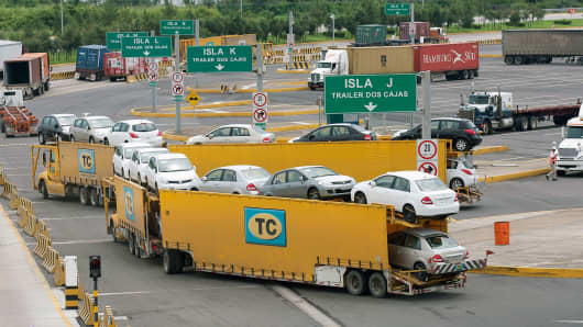 A truck transports new Volkswagen AG cars at the Port of Veracruz, Mexico.