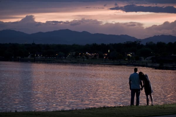 Young couple enjoying the sunset and each others' company at Sloan's Lake in Denver, Colorado.