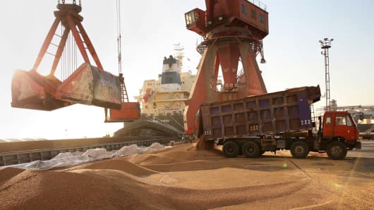 Workers transport imported soybeans at a port in Nantong, China April 9, 2018.