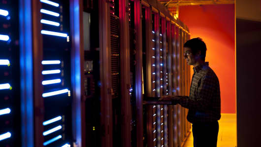 Systems engineer configuring servers in data center.