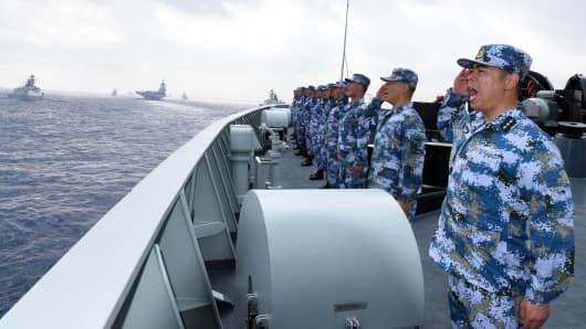 A PLA Navy fleet including the aircraft carrier Liaoning, submarines, vessels and fighter jets take part in a review in the South China Sea on April 12, 2018.