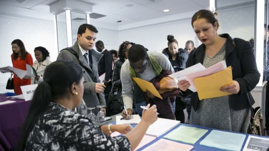 A New York Department of City Administrative Services representative, left, speaks with job seekers during a Catalyst Career Group job fair in New York.