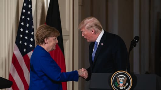 German Chancellor Angela Merkel and U.S. President Donald Trump shake hands during their joint press conference in the White House on Friday, April 27, 2018.