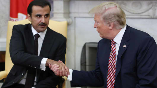 President Donald Trump, right, and Sheikh Tamim bin Hamad Al Thani, the Emir of Qatar, shake hands during a meeting in the Oval Office of the White House in Washington, D.C., on Tuesday, April 10, 2018.