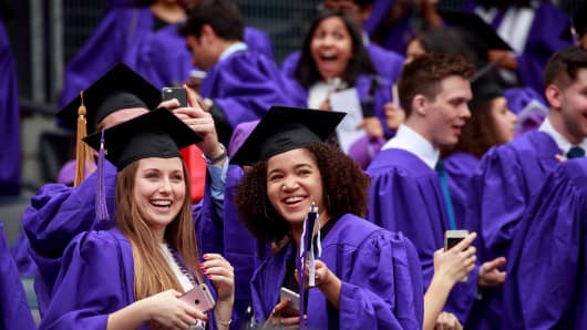 Graduating students wait for the start of New York University's commencement ceremony at Yankee Stadium, May 16, 2018 in the Bronx borough of New York City.