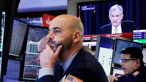 Federal Reserve Chairman Jerome Powell appears on a television on the floor of the New York Stock Exchange.