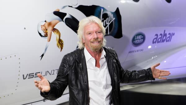 Sir Richard Branson in front of Virgin Galactic's Unity spacecraft