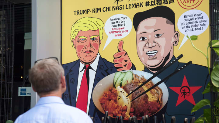 A man looks at a promotional poster outside a local eatery, Harmony Nasi Lemak, which offers a special Trump Kim-Chi dish to its menu on June 6, 2018 in Singapore.