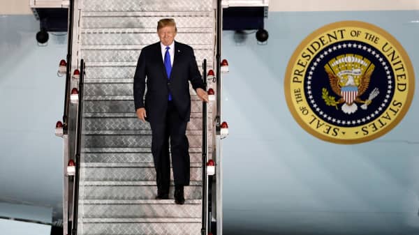 President Donald Trump steps off his plane as he arrives at Paya Lebar Air Base in Singapore, ahead of a summit with North Korean leader Kim Jong Un, June 10, 2018.