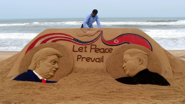 Indian artist Sudarshan Pattnaik, 65, finishes a sand sculpture depicting US President Donald Trump and North Korean leader Kim Jong-un at Puri beach on June 11, 2018, ahead of the US-North Korea summit.
