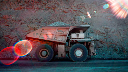 An industrial dump truck transports a load of rocks at a copper mine in Arizona.