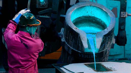 An employee pours molten steel into a casting for a church bell at the Verdin Corp. production facility in Cincinnati, Ohio.