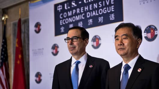 US Secretary of the Treasury Steven Mnuchin (L) and Chinese Vice Premier Wang Yang pose for a photo before an opening session at a US and China comprehensive Economic Dialogue at the US Department of the Treasury July 19, 2017 in Washington, DC. 