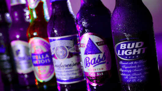 Bottles of Anheuser-Busch's Bud Light, Budweiser and Budweiser Select and InBev NV's Bass, Stella Artois, and Hoegarden are arranged for a photograph at the Van Goghz Martini Bar & Bistro in St. Louis, Missouri.