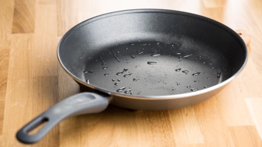 Teflon frying pan on wooden table