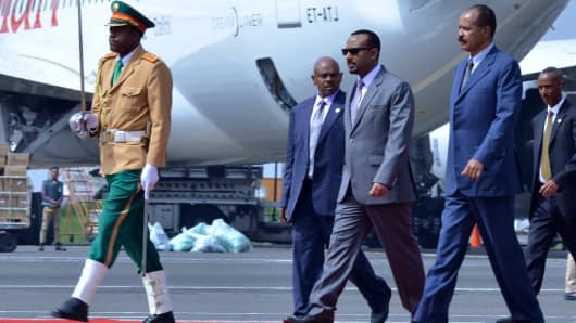 Eritrea's President Isaias Afwerki (second right) is received by Ethiopia's Prime Minister Abiy Ahmed (third right) as he arrives at Bole International airport in Addis Ababa on July 14, 2018.