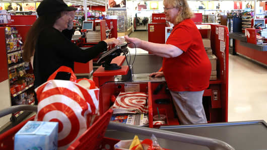 A Target worker helps a customer at a Target store in San Rafael, California. 