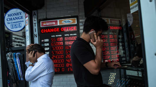 People check currency exchange rates at a currency exchange office on August 11, 2018 in Istanbul.Â 