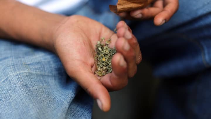 A man prepares to smoke K2 or 'Spice', a synthetic marijuana drug.