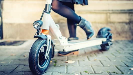 Close up details of modern transportation, electric kick scooter, Portrait of girl riding the city transportation