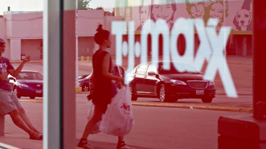 The reflection of shoppers are seen in a window at a TJ Maxx store in Peoria, Illinois.