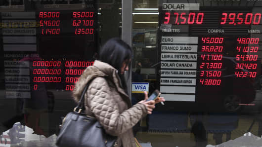 Currency exchange values are displayed in the buy-sell board of a bureau de exchange in Buenos Aires, on August 31, 2018. - Argentina's peso began to recover on Friday as markets opened, making a tiny 0.68 percent gain after losing 20 percent of its value against the dollar over the previous two days.